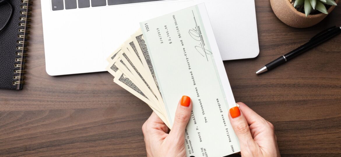 close-up-hands-holding-cash-check